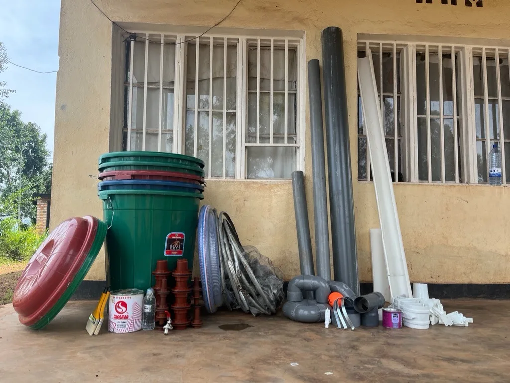 Tanks, lids, pipes and fittings laid out on a veranda